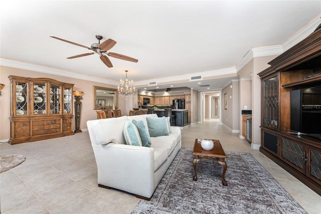 living room with ceiling fan with notable chandelier, light tile patterned floors, and crown molding