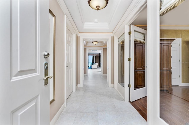 hall with crown molding and light tile patterned flooring