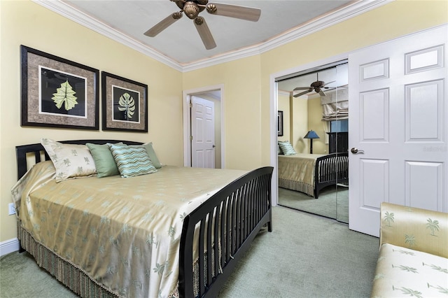 carpeted bedroom with ceiling fan, crown molding, and a closet