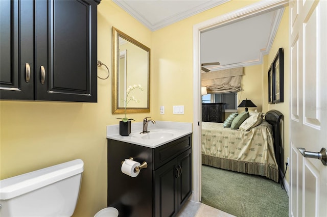 bathroom with crown molding, vanity, and toilet