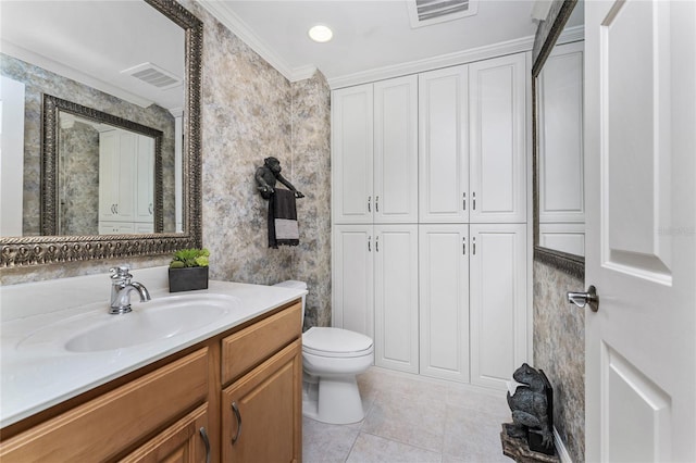 bathroom with toilet, vanity, tile patterned flooring, and ornamental molding