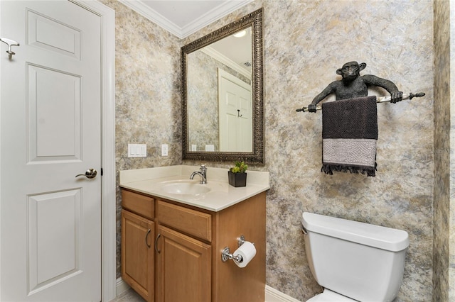 bathroom with toilet, ornamental molding, and vanity