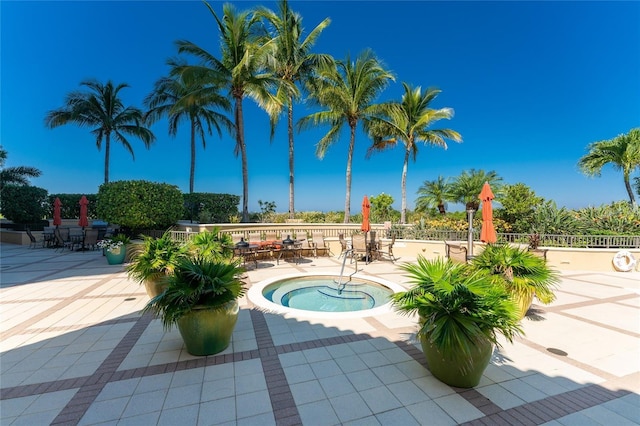 view of swimming pool featuring a community hot tub and a patio