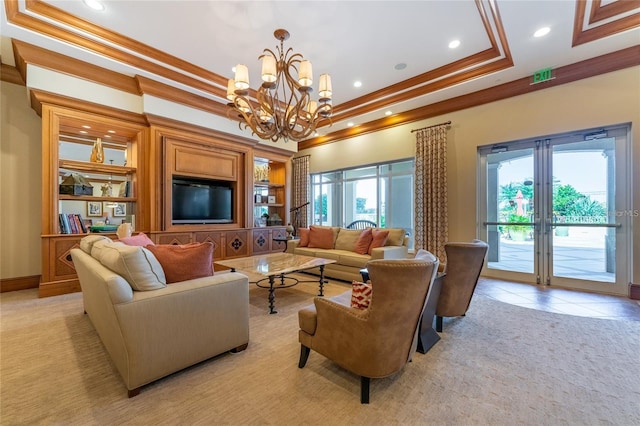 carpeted living room featuring a tray ceiling, crown molding, and a chandelier