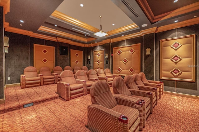 home theater room featuring carpet floors, a tray ceiling, and crown molding