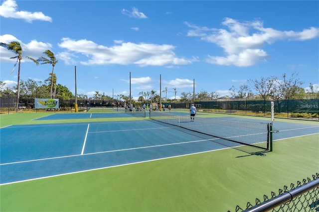 view of tennis court featuring basketball hoop