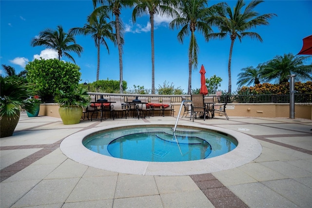 view of swimming pool featuring a bar and a patio