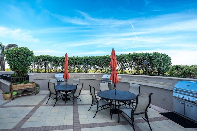 view of patio featuring exterior kitchen and a grill