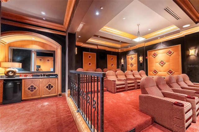 carpeted cinema room featuring sink and ornamental molding