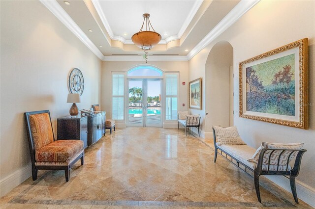 living area with crown molding, a tray ceiling, and french doors