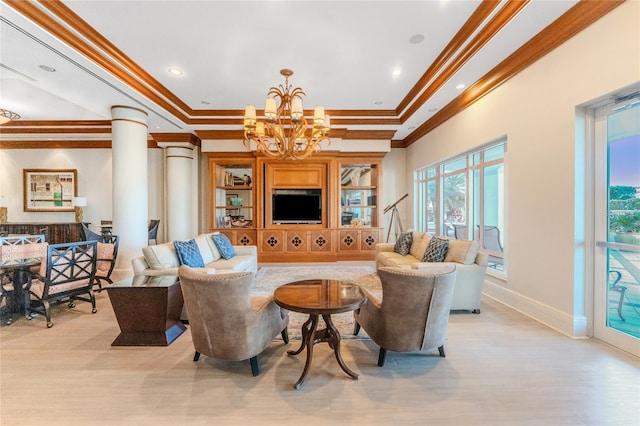 living room with crown molding, an inviting chandelier, light wood-type flooring, a tray ceiling, and decorative columns