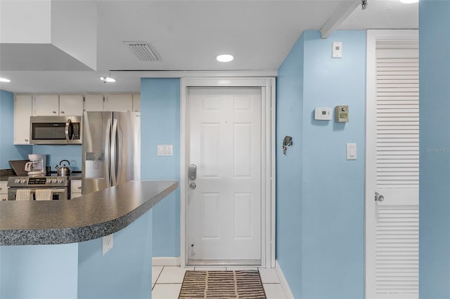 kitchen featuring light tile patterned floors and stainless steel appliances