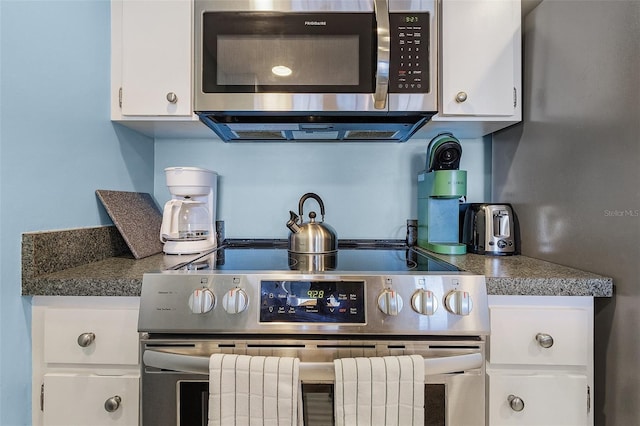 kitchen featuring appliances with stainless steel finishes and white cabinetry