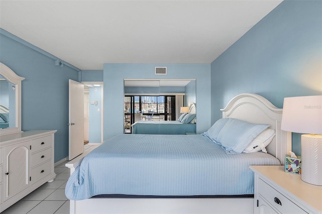 bedroom with light tile patterned floors