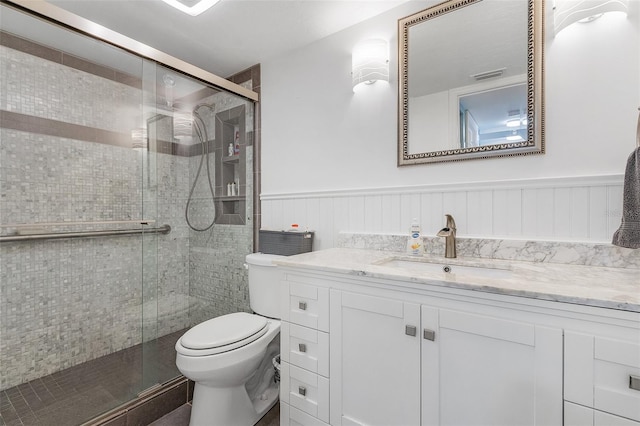 bathroom with vanity, toilet, and walk in shower