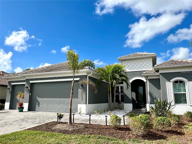 mediterranean / spanish-style home with a garage