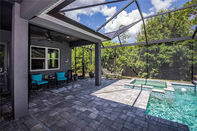 view of patio / terrace with ceiling fan, glass enclosure, and a swimming pool with hot tub