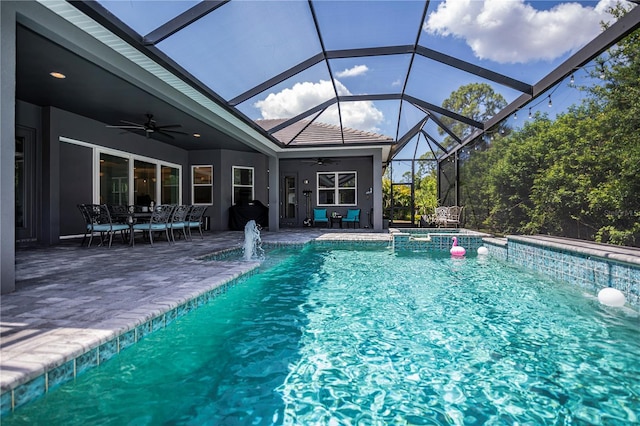 view of pool with a lanai, ceiling fan, and a patio