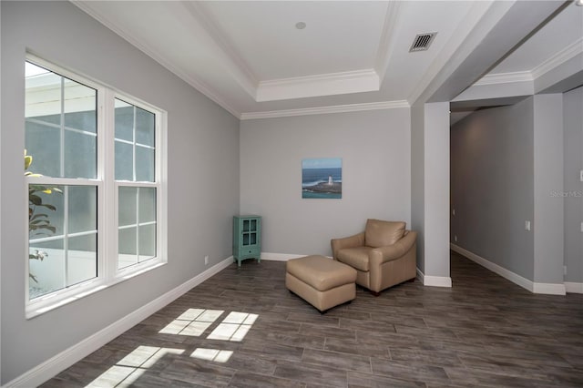 unfurnished room with dark wood-type flooring, a raised ceiling, and crown molding