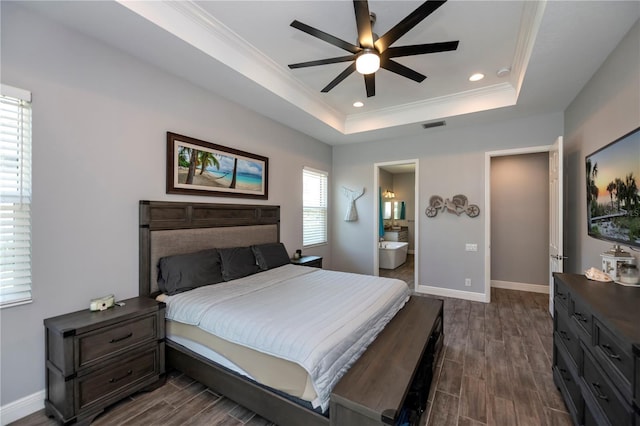 bedroom featuring dark wood-type flooring, ensuite bathroom, ceiling fan, and multiple windows