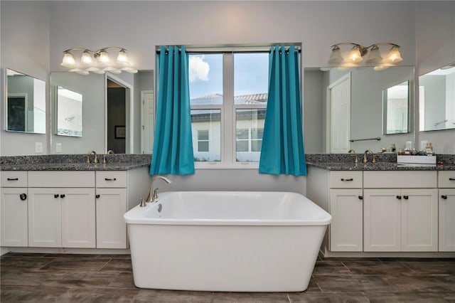 bathroom with a bathing tub, vanity, and hardwood / wood-style flooring