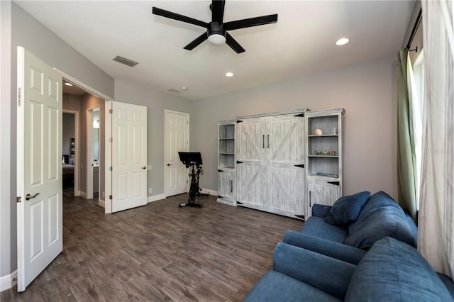 living area featuring dark hardwood / wood-style flooring and ceiling fan