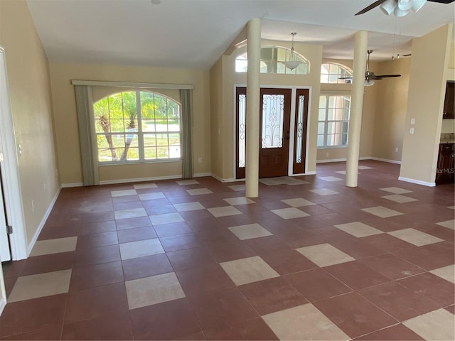 foyer with ceiling fan and decorative columns