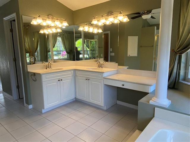 bathroom with decorative columns, vanity, lofted ceiling, and tile patterned flooring