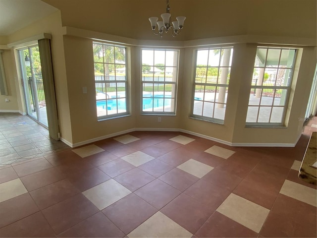 unfurnished dining area with a chandelier and tile patterned floors