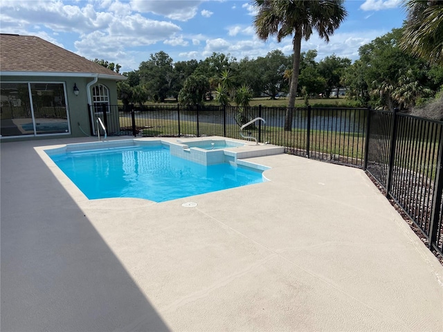 view of swimming pool with an in ground hot tub and a patio