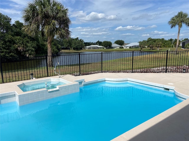 view of pool with an in ground hot tub and a lawn