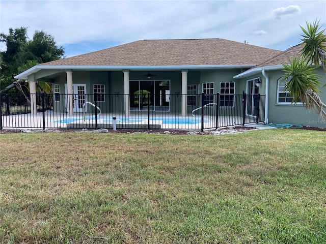 rear view of house featuring a fenced in pool, a patio, ceiling fan, and a yard