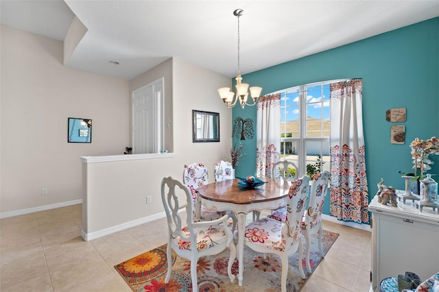 tiled dining area featuring a chandelier