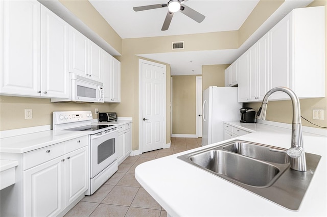 kitchen featuring white cabinetry, sink, ceiling fan, white appliances, and light tile patterned flooring