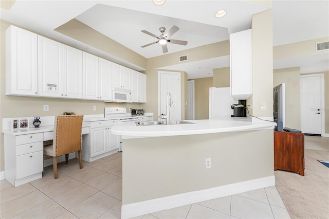 kitchen featuring white cabinetry, sink, kitchen peninsula, white appliances, and light tile patterned floors