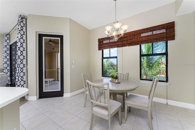 tiled dining area featuring a notable chandelier