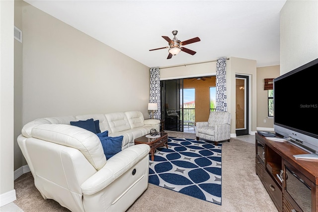 carpeted living room with ceiling fan