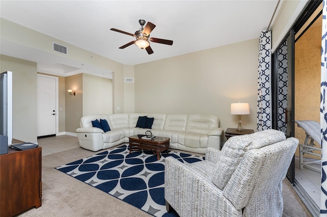 living room with ceiling fan and light colored carpet