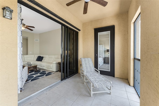 balcony featuring a patio and ceiling fan