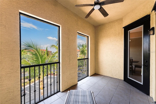 unfurnished sunroom with ceiling fan