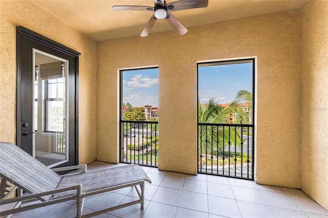 sunroom / solarium featuring plenty of natural light and ceiling fan