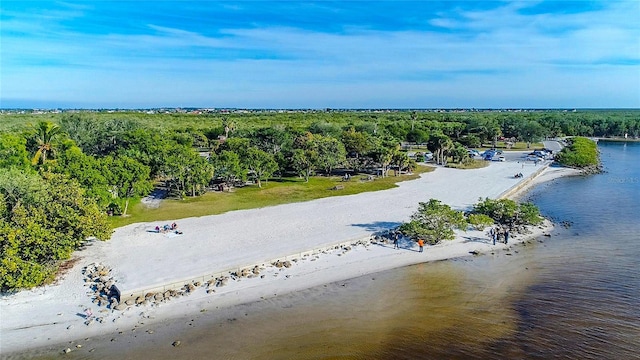 birds eye view of property with a water view and a view of the beach