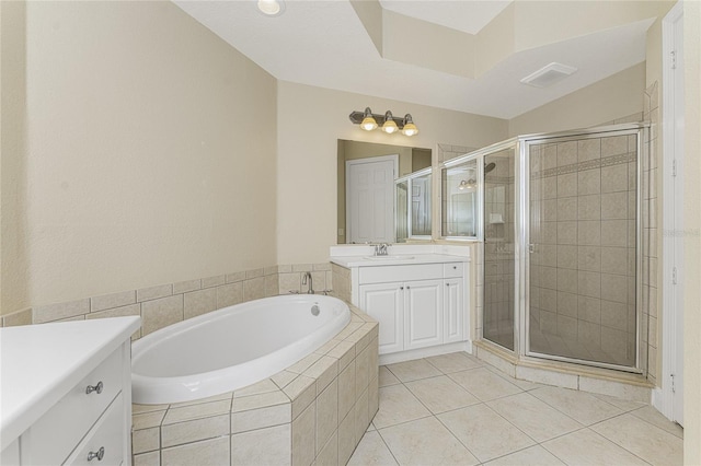 bathroom with tile patterned floors, vanity, and independent shower and bath