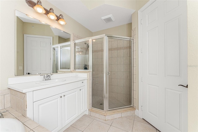 bathroom featuring tile patterned floors, vanity, and walk in shower