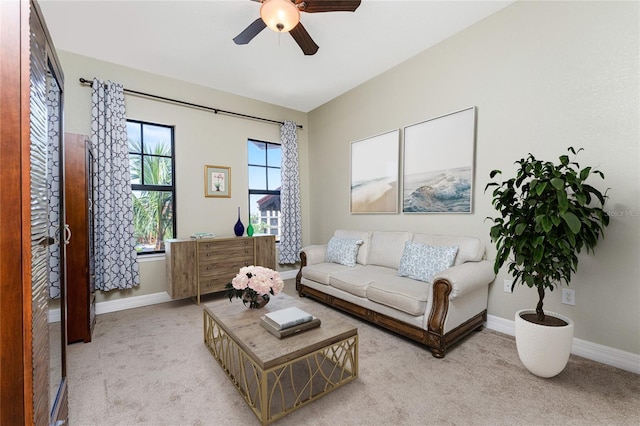 living room with ceiling fan and light colored carpet