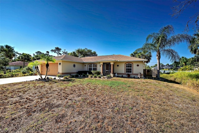 ranch-style home with a garage and a front yard