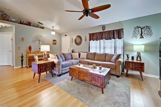 living room with ceiling fan, light hardwood / wood-style flooring, and vaulted ceiling