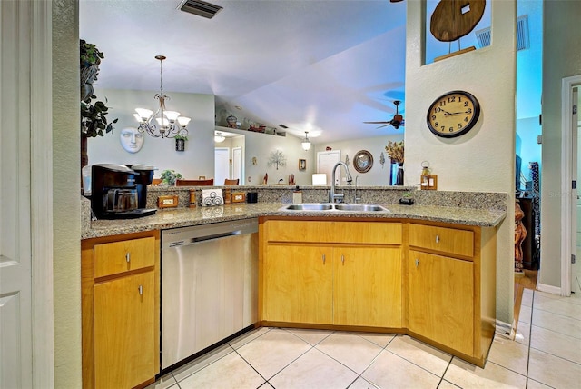 kitchen featuring light stone countertops, sink, light tile patterned floors, and stainless steel dishwasher