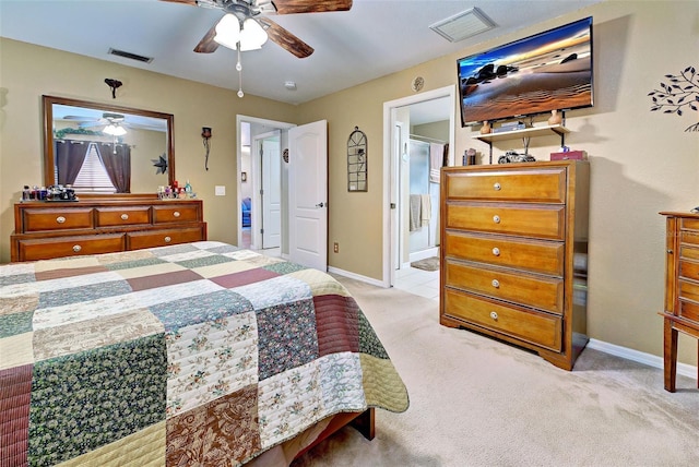 carpeted bedroom featuring connected bathroom and ceiling fan