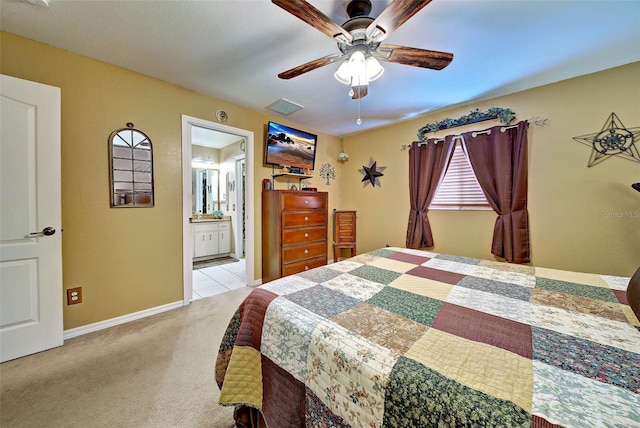 carpeted bedroom with connected bathroom and ceiling fan